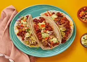 Bold ‘n’ Beefy Tacos with Tangy Slaw, Pico, & Guacamole Cream recipe