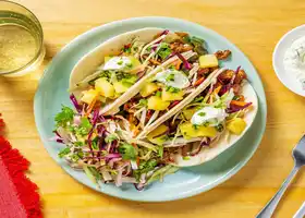 Caribbean-Inspired Pork Tacos with Pineapple, Slaw and Cilantro Crema recipe