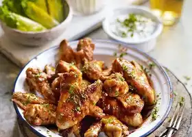Buffalo chicken wings with celery sticks and blue cheese dip recipe